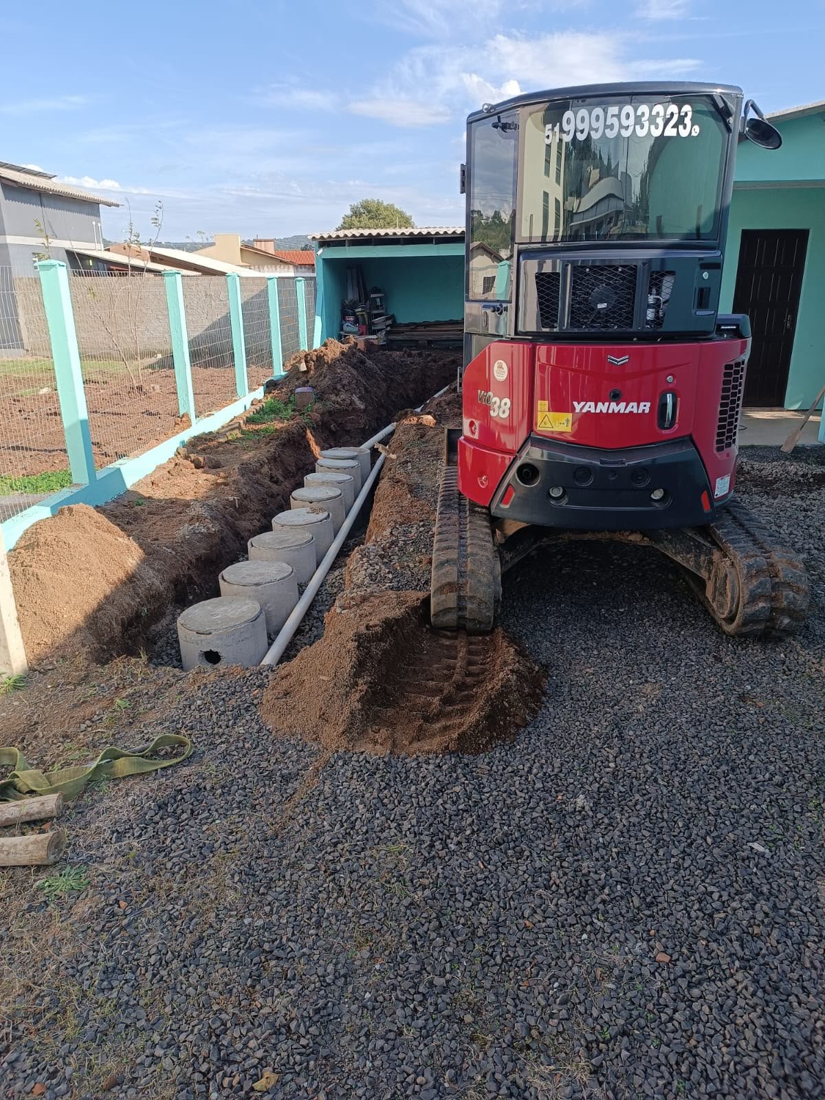 Mini escavadeira operando em pátio residencial